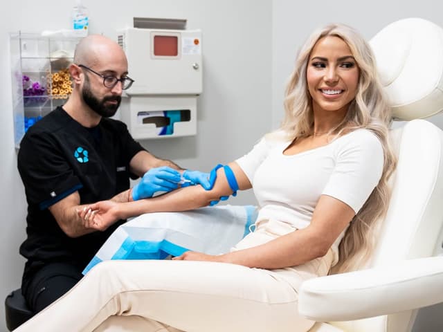 A smiling patient during her blood draw