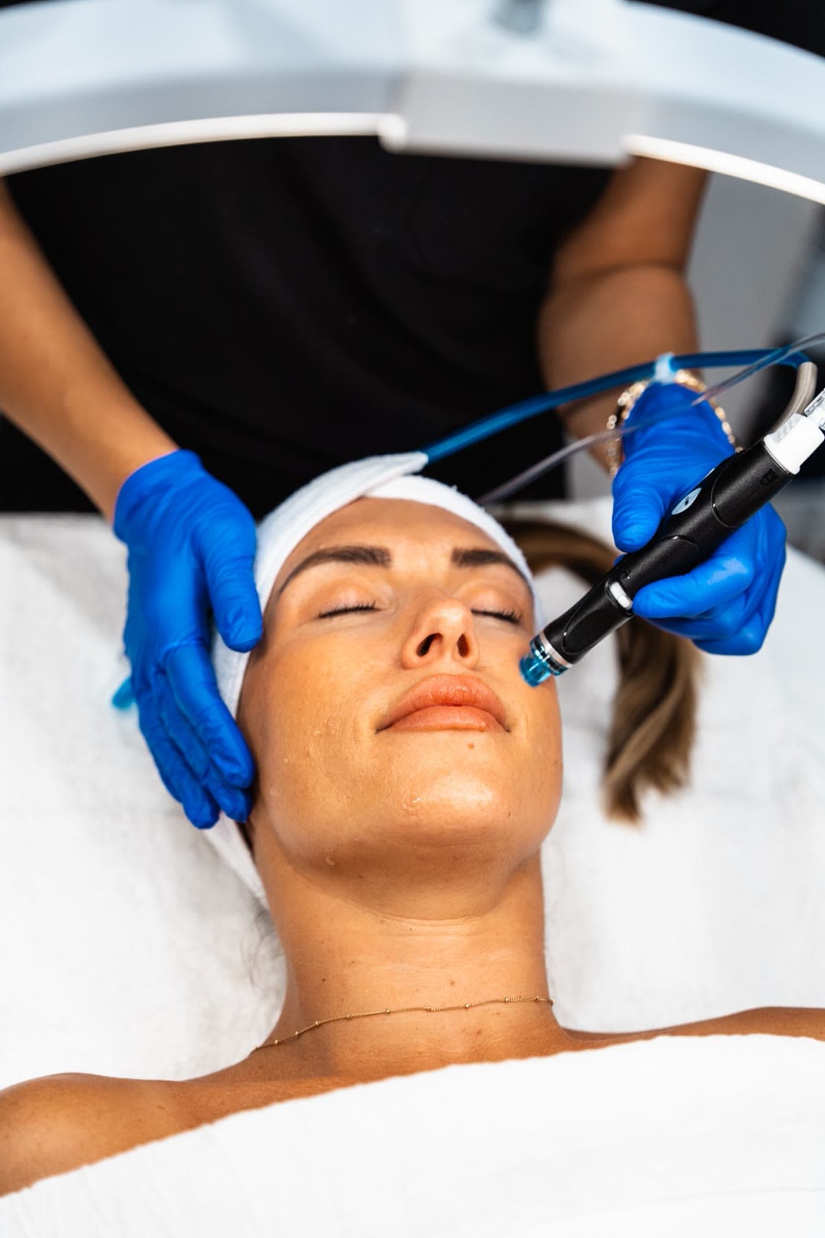 A smiling patient relaxes during her HydraFacial