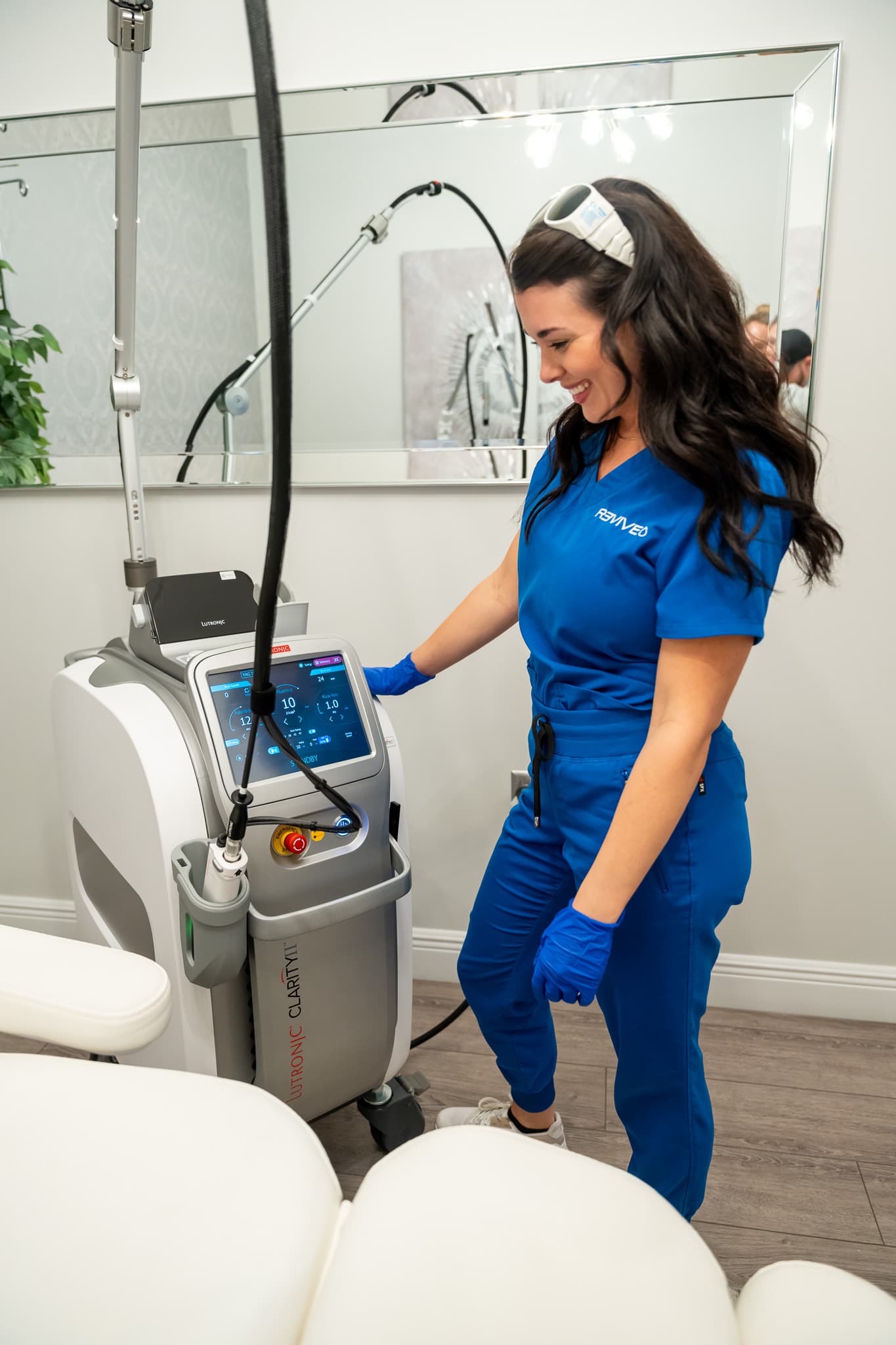 A Relive clinician prepares the laser resurfacing device in a treatment room at Relive Health Stuart