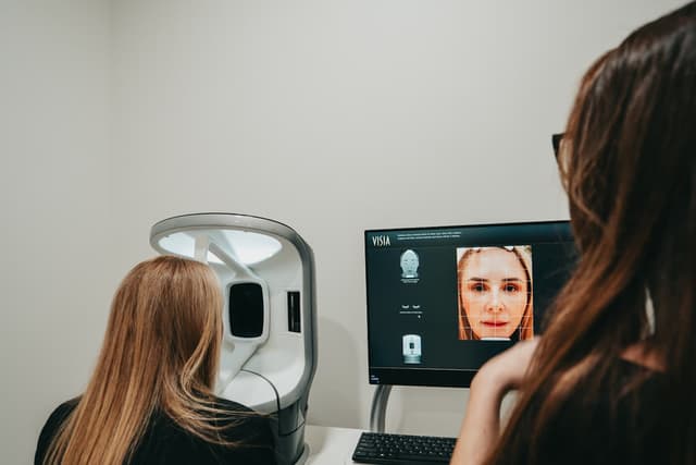 A provider and patient reviewing skin analysis results together