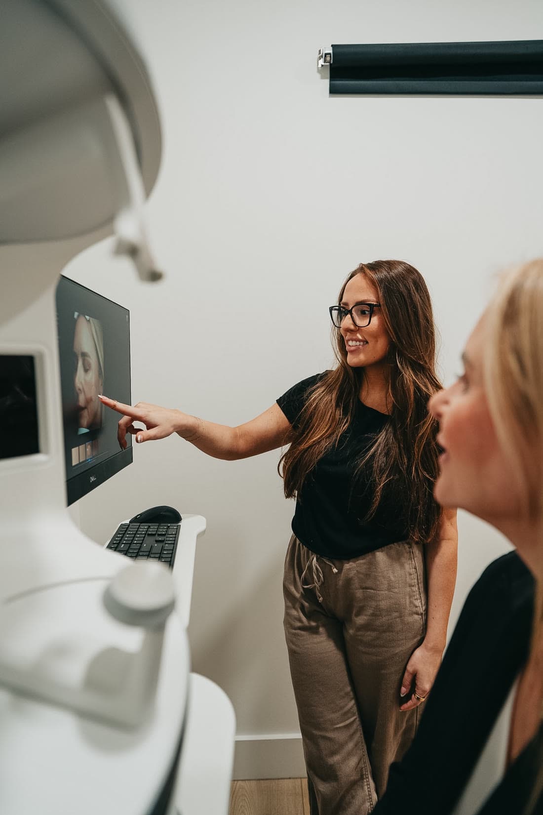 A Relive provider walking a patient through her Visia skin analysis results